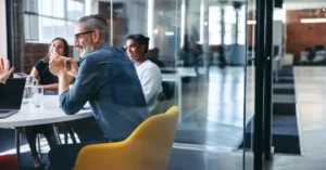 cheerful businessman attending a meeting with his team