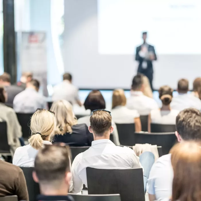 male business speaker giving a talk at business conference event male business speaker giving a talk at business conference event